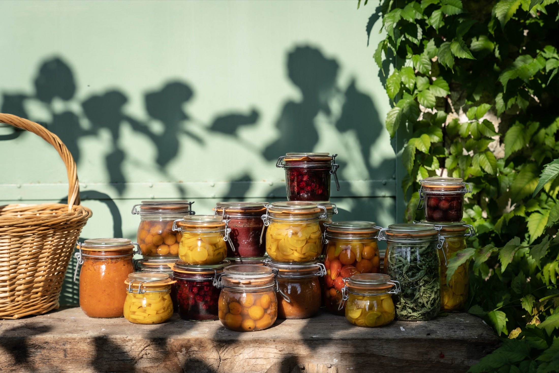 Le Parfait glass jars filled with colorful preserves on a garden bench
