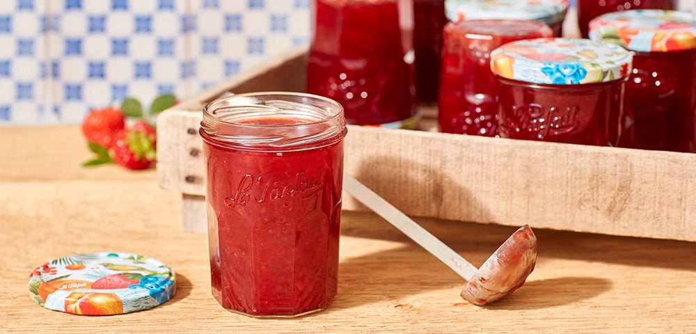 Le Parfait jam jars filled with homemade strawberry jam on a wooden tray