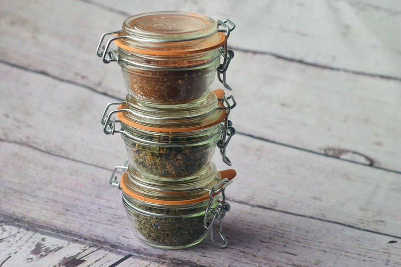 A beautiful wooden board displaying a variety of gourmet salts.