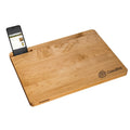 A maple wood cutting board being used to chop vegetables.
