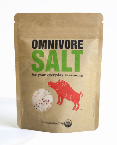 Jar filled with organic omnivore seasoning blend on counter.