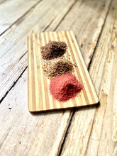 Load image into Gallery viewer, ChouAmi Gourmet Sea Salt Trio - three mounds of chipotle, hickory smoke, and alaea sea salt on a bamboo board.