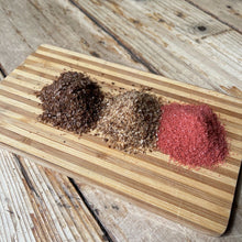 Load image into Gallery viewer, ChouAmi Gourmet Sea Salt Trio top view - three mounds of chipotle, hickory smoke, and alaea sea salt on a board.