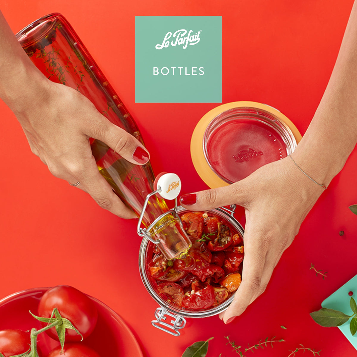 Le Parfait Bottles product card - hand pouring olive oil from a swing-top bottle into an open hermetic jar of sun-dried tomatoes.