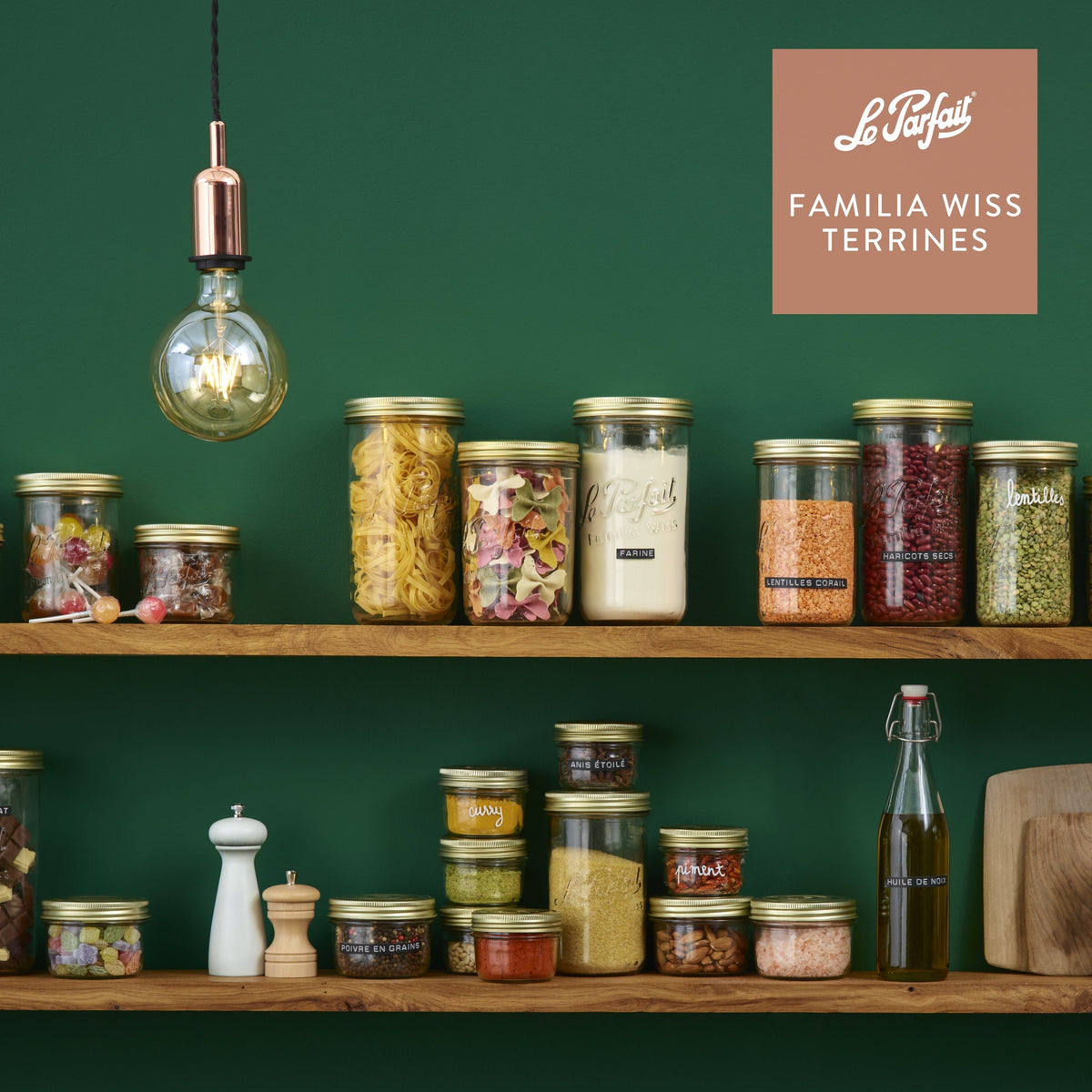 Le Parfait Familia Wiss Terrines lining pantry shelves with pasta, flour, lentils, beans, spices, and candies under a brass pendant lamp.
