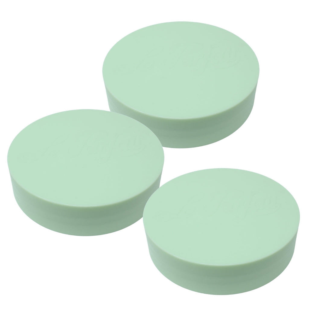 Three mint Le Parfait plastic screw-top jar lids stacked together, embossed logo on top.