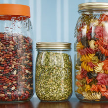 Load image into Gallery viewer, Le Parfait Screw Top Jars on a pantry shelf - orange-lid jar of mixed beans, gold metal-lid split peas, and gold metal-lid multicolor pasta.