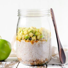 Load image into Gallery viewer, Le Parfait Super jar layered as overnight oats: granola, chia pudding, caramel, and diced green apple with a wooden spoon resting on the rim.