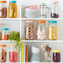 Load image into Gallery viewer, Open kitchen shelves of Le Parfait Screw Top Jars in mixed lid colors filled with granola, dried fruit, walnuts, meringues, pasta, and cookies.