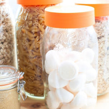 Load image into Gallery viewer, Le Parfait Screw Top Jar with orange lid filled with white meringues in a pantry beside jars of pasta and granola.