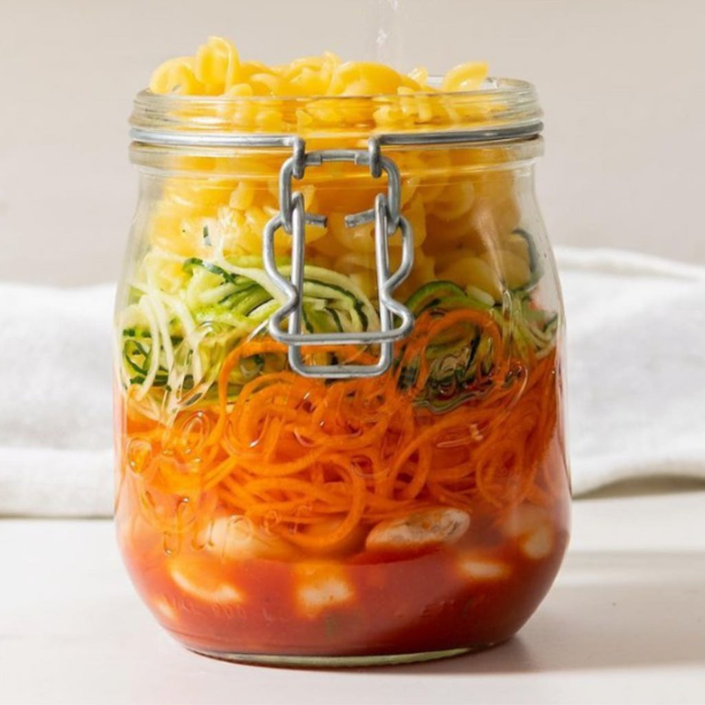 Le Parfait Super Jar layered with pasta, spiralized zucchini and carrot, white beans, and tomato sauce for a make-ahead meal.