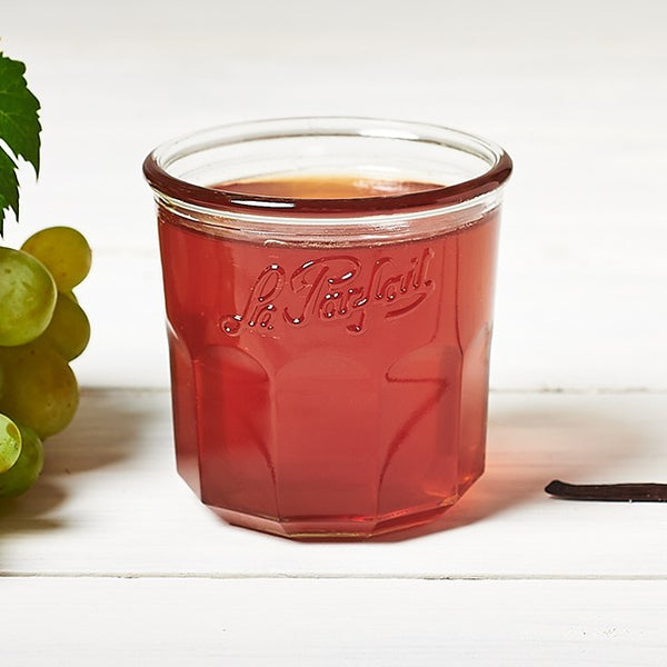 Clear grape jelly in an embossed Le Parfait jar