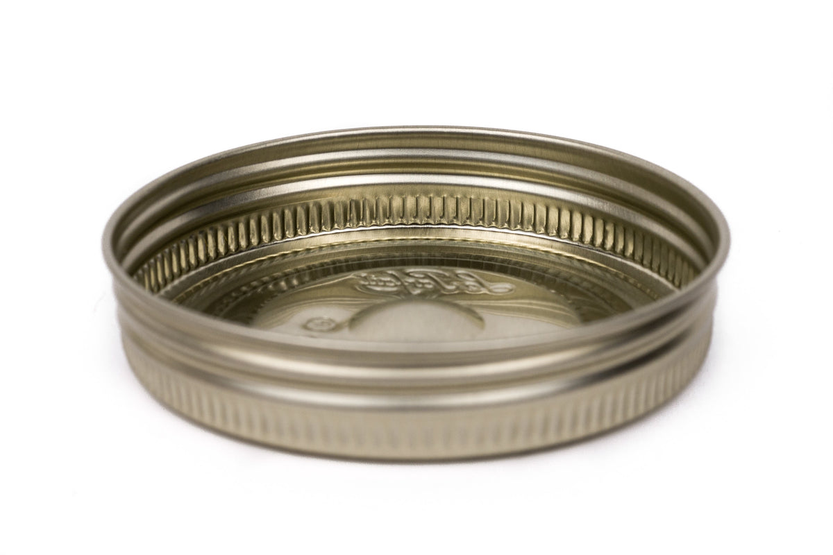 Single gold Le Parfait Familia Wiss metal screw lid in 110mm size - side profile on white.