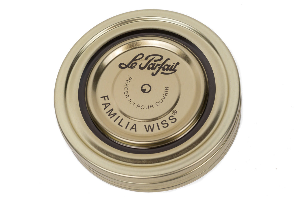 Top-down Le Parfait Familia Wiss sealing cap with dark border indicating 110mm size - 'pierce-here' pre-marked center.