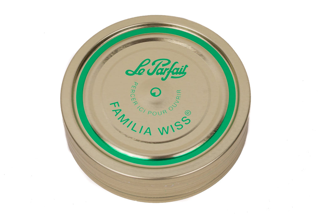 Top-down Le Parfait Familia Wiss sealing cap with green 'pierce-here' indicator and 'Le Parfait Familia Wiss' branding.