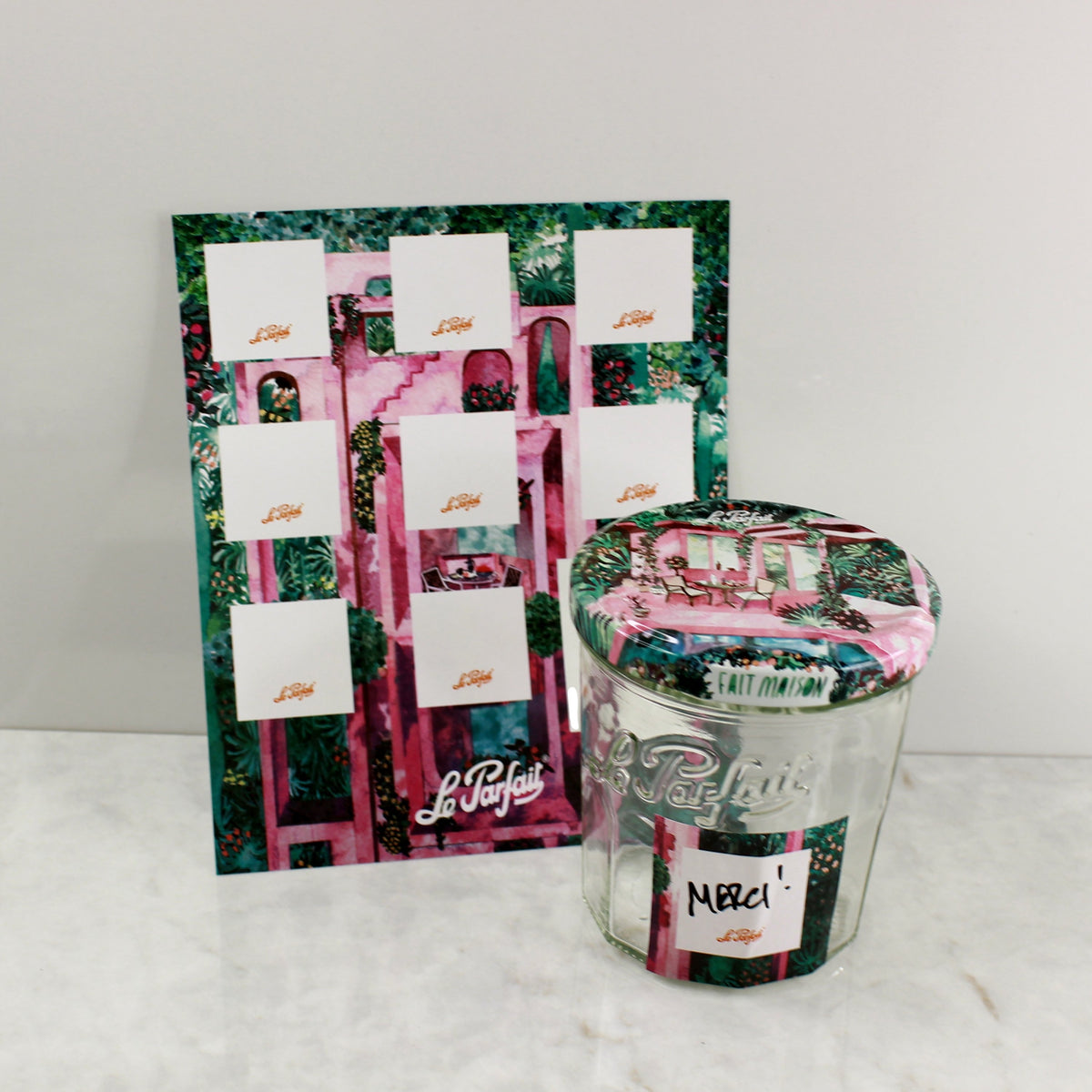 Le Parfait Labels pink garden cabana sheet beside a Le Parfait jar with matching pink cabana lid and a 'Merci!' label.