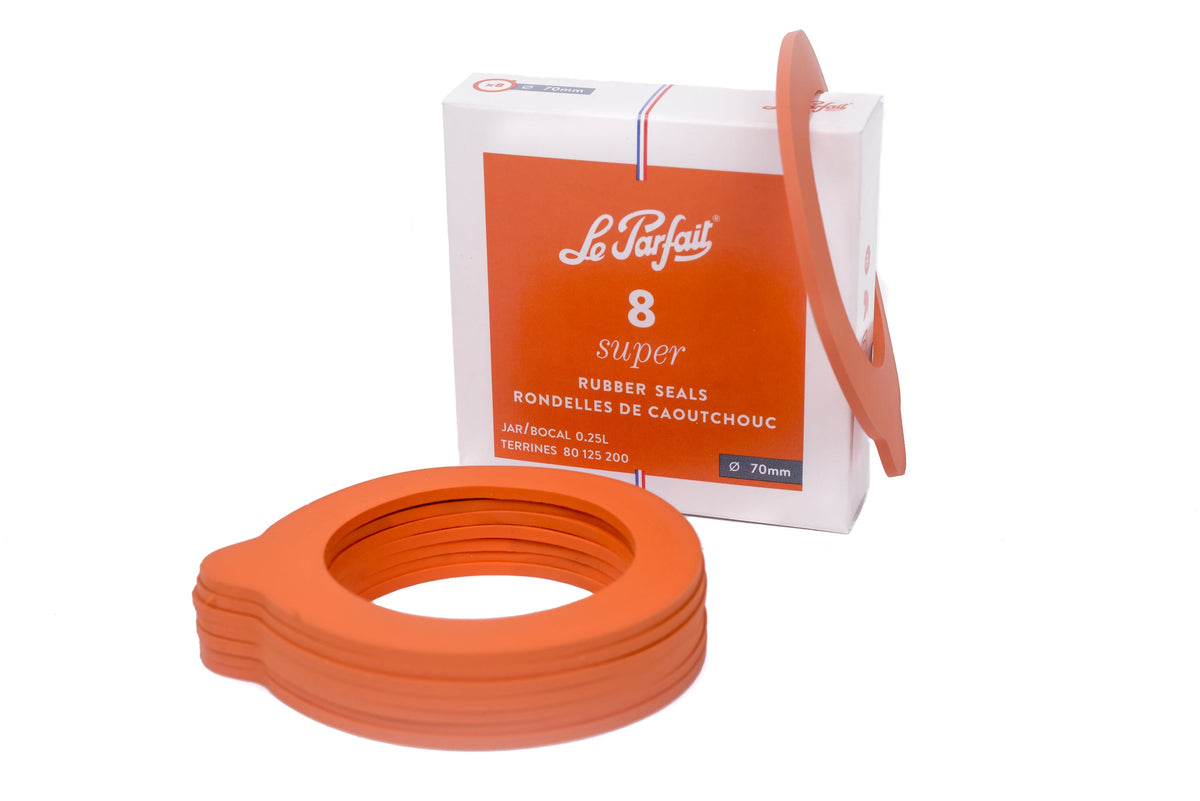 A stack of orange Le Parfait rubber gaskets.
