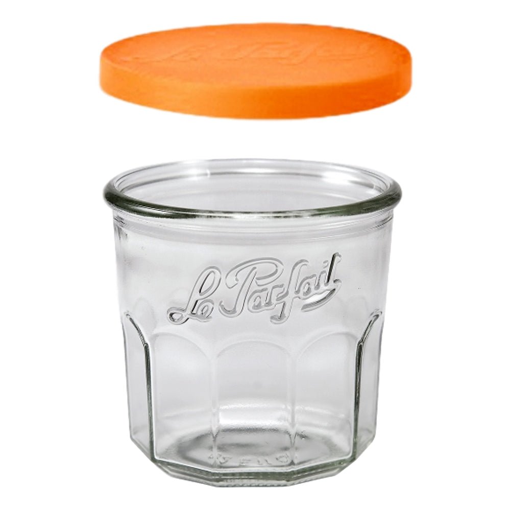 Glass jar topped with orange Le Parfait snap cover lids.