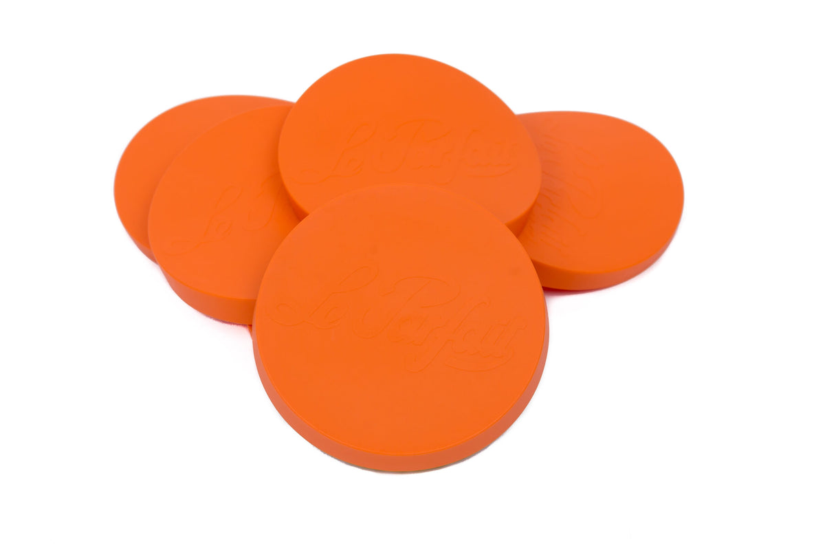 Five orange Le Parfait Super Snap Cover Lids in a cluster, embossed Le Parfait branding visible.