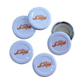 White Le Parfait milk bottle caps displayed on white background.