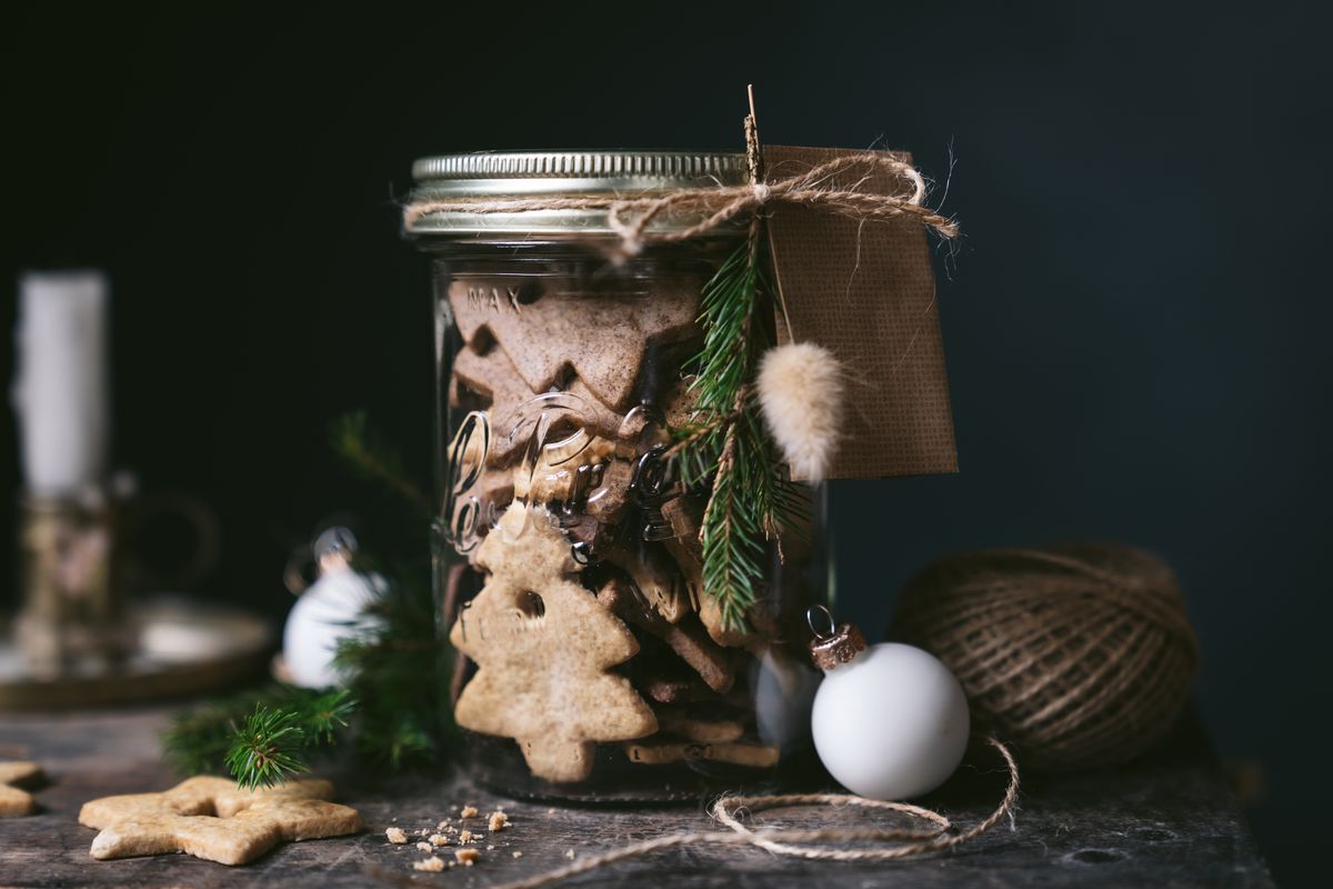A Le Parfait Familia Wiss jar of holiday cookies tied with twine and a gift tag