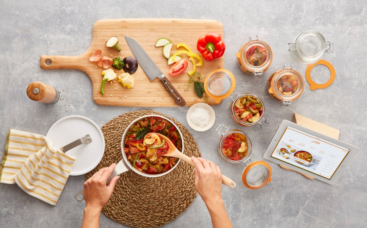 Preparing vegetables in Le Parfait Super Jars at a kitchen table