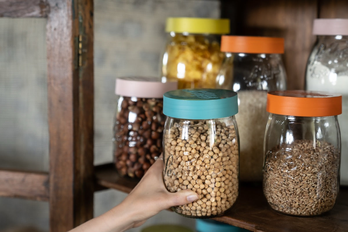 Le Parfait Screw Top Jars filled with chickpeas, grains, and beans in a pantry